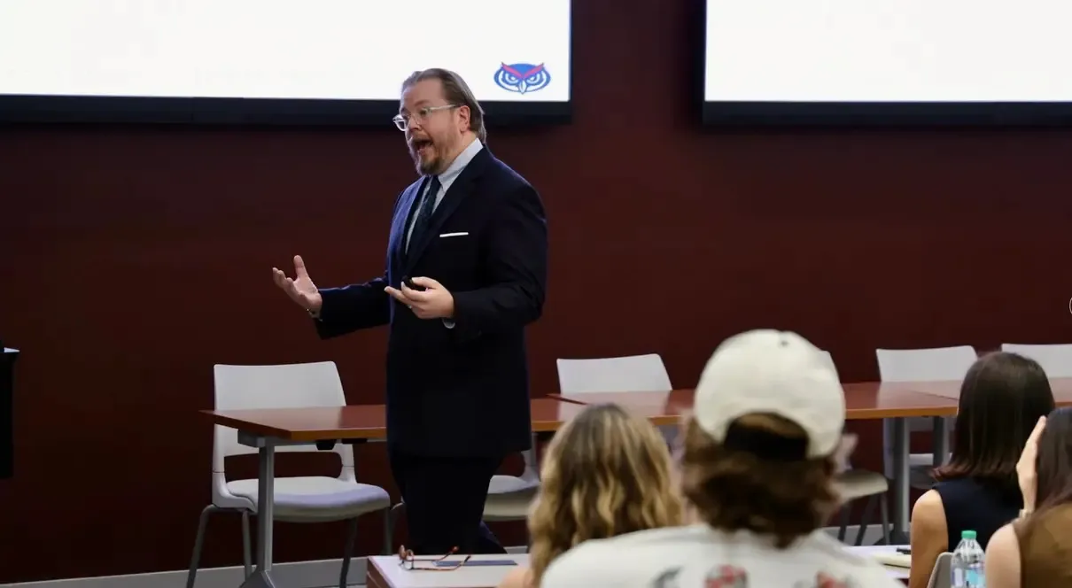Bryan Cutsinger lecturing to an audience during Adam Smith Week at the College of Charleston